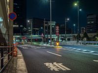 an image of outside of the night time building with the lights turned on and the streets empty