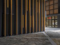 a walkway leading up to a wooden wall next to a cement area with floor tiles