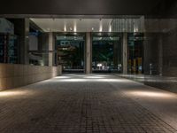 an open door at the lobby of a modern building with glass doors on either side