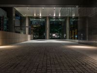 an open door at the lobby of a modern building with glass doors on either side