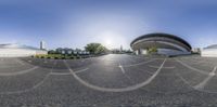 a view of the parking lot from a fish eye lens, including an oval driveway