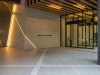 a hallway with columns on the wall that have led lights coming out of them and a door is behind the wall