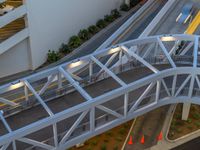 a view of a road and an overpass with traffic passing through it by buildings