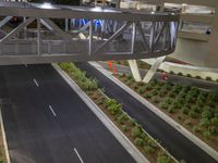 a view of a road and an overpass with traffic passing through it by buildings