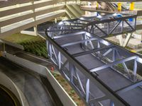 a view of a road and an overpass with traffic passing through it by buildings