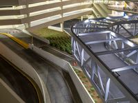 a view of a road and an overpass with traffic passing through it by buildings