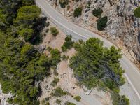 an aerial view of a road and mountain side road in croatia, shot from above