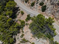 an aerial view of a road and mountain side road in croatia, shot from above