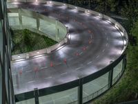 a view of a road and an overpass with traffic passing through it by buildings