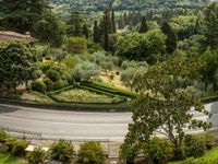 a curved road on the edge of an olive groves and garden area in italy's umberica