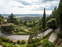 a curved road on the edge of an olive groves and garden area in italy's umberica