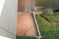 an overhead picture of a concrete stairs and some grass with a sky background on top of it