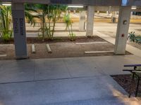 there is an empty parking garage under a building that features columns and steps, but with a bicycle leaning on a wall