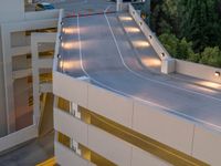 a view of a road and an overpass with traffic passing through it by buildings