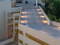 a view of a road and an overpass with traffic passing through it by buildings