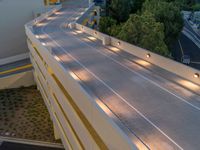 a view of a road and an overpass with traffic passing through it by buildings