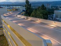 a view of a road and an overpass with traffic passing through it by buildings