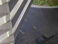 a view of a road and an overpass with traffic passing through it by buildings