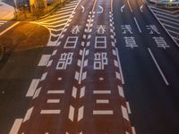 an image of outside of the night time building with the lights turned on and the streets empty