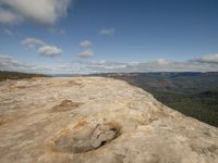 this is an empty rock at the top of a mountain with a view out over the valley