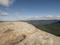 this is an empty rock at the top of a mountain with a view out over the valley