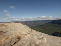 this is an empty rock at the top of a mountain with a view out over the valley