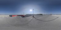 the view from the top of a ramp looking at an empty parking lot in the sun