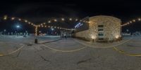 a view from the rear of a 360 - angle of a brick building in an empty parking lot