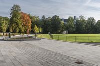 a man riding a skateboard down the side of a brick road next to trees