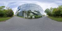 a view of the exterior of a modern building while 360 - glasses work on the side