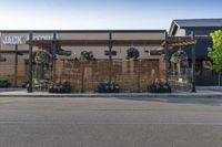 a wooden awning and a building with flowers in front of it on an empty street