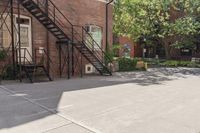 a fire hydrant on a street with stairs going up behind it, near an old brick building