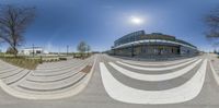 a camera panorama shows a man with a skateboard in his hand riding up a stair