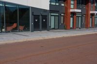 a brick street with two different chairs next to it and an outside restaurant in the background