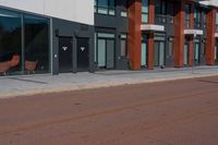 a brick street with two different chairs next to it and an outside restaurant in the background