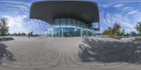 a fish eye shot looking into the entrance of an building with a domed glass facade