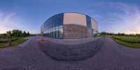 a reflection image shows the exterior of a building on the grass and in front of the sky