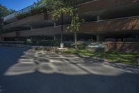 a building with a parking lot next to it's walkways and trees in the background