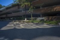 a building with a parking lot next to it's walkways and trees in the background