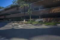 a building with a parking lot next to it's walkways and trees in the background