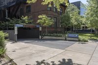 a sidewalk is near the building next to trees and a sidewalk lamp and stairs on the right side