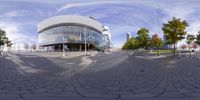 a 360 view shows a circular parking lot and the building with several windows is in a blue sky