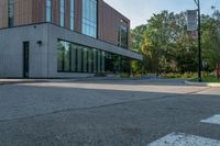 the street in front of the building is empty from cars as if it were not on the sidewalk