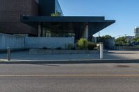 the view of an empty parking lot near an office building while it is sunlit