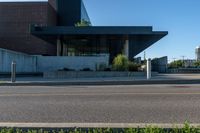 the view of an empty parking lot near an office building while it is sunlit