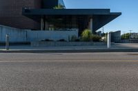 the view of an empty parking lot near an office building while it is sunlit