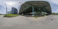 the fish eye view of an empty parking lot with people in it and two cars parked on one side of the street