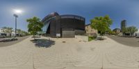 this is a circular panoramic view of a large building with a clock at the top