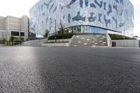 a man riding a skateboard down the middle of an empty street under a building