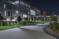 a city square in the dark with a bright street light next to the building at night